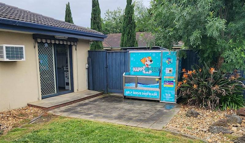 The dog wash on a paved patio beside Pound Road Vet Clinic, with a lawn in front